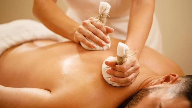 Traditional Ayurvedic massage therapy in a natural Kerala setting